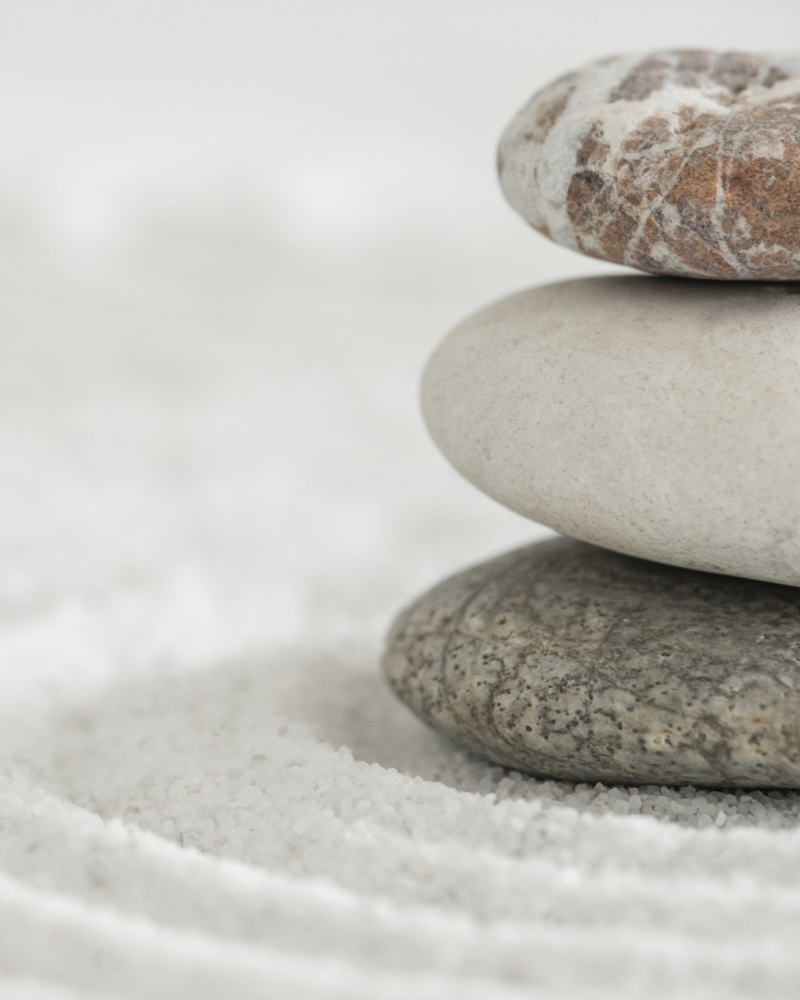 stacked-zen-stones-sand-background-art-balance